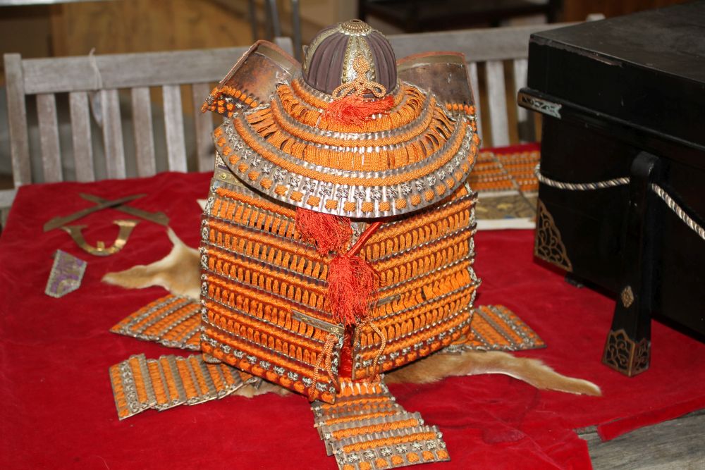 A Japanese late Meiji period suite of model Samurai armour, made from gilt and lacquered wood, braiding and thin metal, with partial di